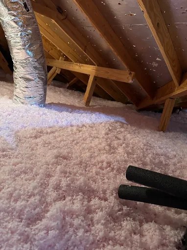 Pink blown-in fiberglass attic insulation at full depth in Boca Raton, FL