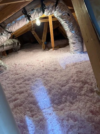 Blown-in attic insulation installed around AC ductwork in Plantation, FL