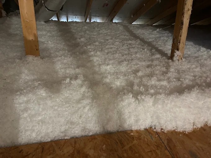 White blown-in fiberglass attic insulation between the joists in Weston, FL